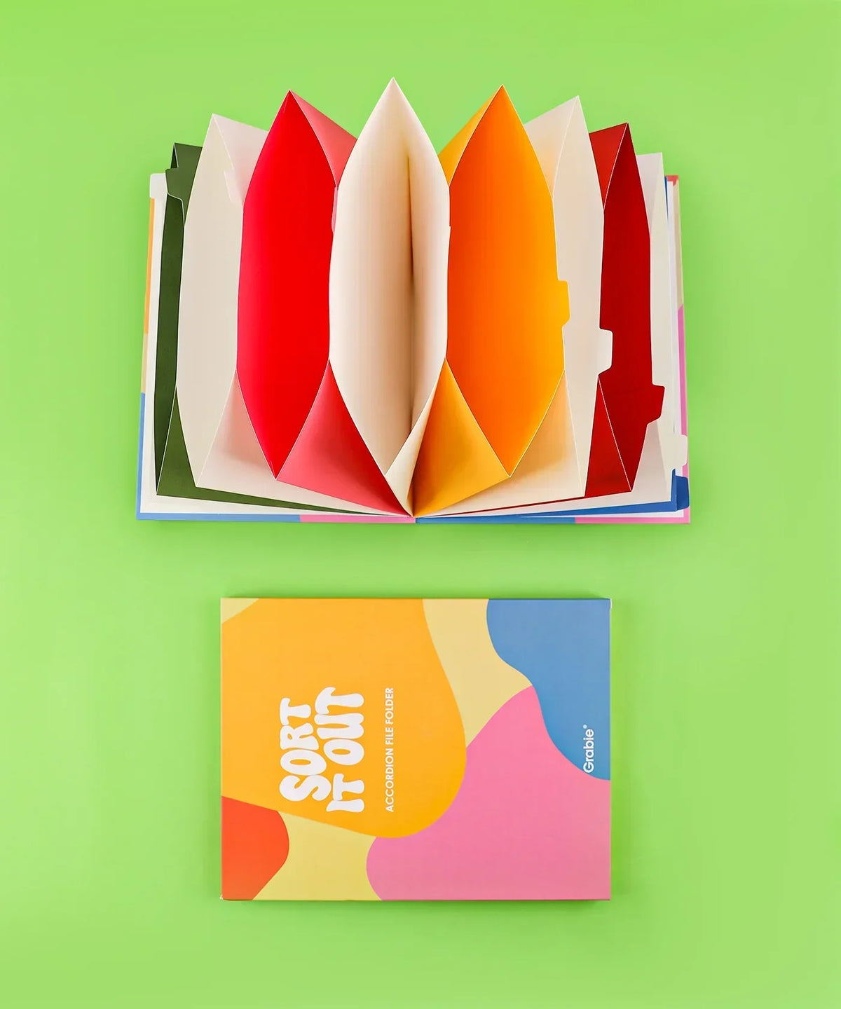 Let Your Feelings Flow Grabie Art Club Box with colorful accordion-style folded art supplies on green background