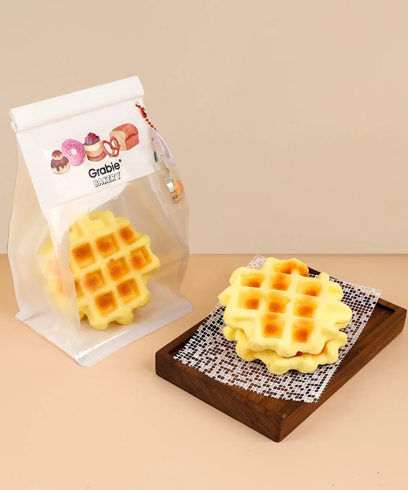 Feel-Good Stress Relief Foam Squishy - Waffle Sandwich displayed in packaging and stacked on a wooden tray.