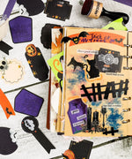 22 Pcs Grabie Exclusive Happy Haunting Sticker Set displayed on an open scrapbook with Halloween-themed designs and art supplies