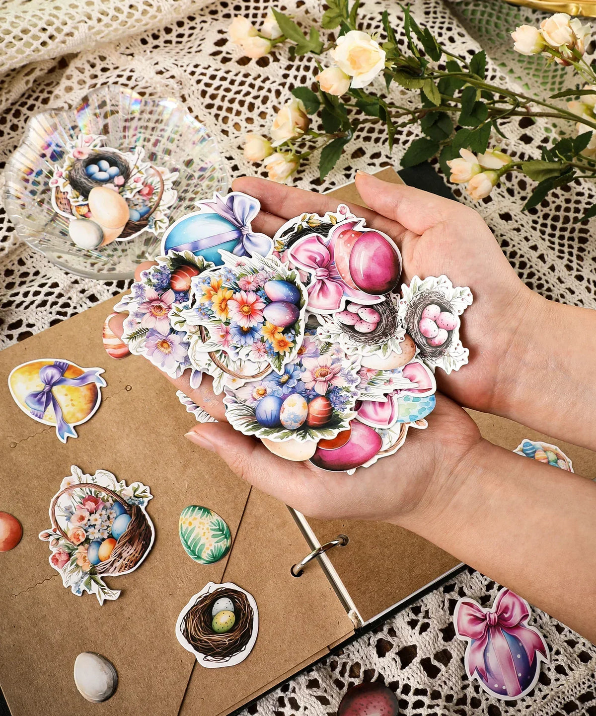 Hands holding colorful Easter egg and flower stickers from the 52 Pcs Grabie Exclusive Hoppy Easter Sticker Set
