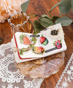 6 Sheets Grabie Exclusive Farmer's Market Sticker Set displayed in a small scrapbook on a decorative glass plate