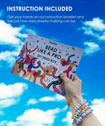 Hand holding Grabie Bead Box instruction booklet against a bright blue sky with white clouds