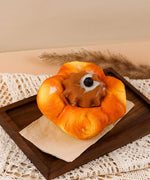 Feel-Good Stress Relief Foam Squishy - Chocolate Flower Bread on wooden tray with textured fabric background