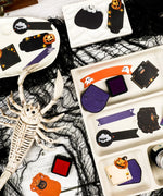 22 Pcs Grabie Exclusive Happy Haunting Sticker Set with Halloween designs and spooky art supplies on trays