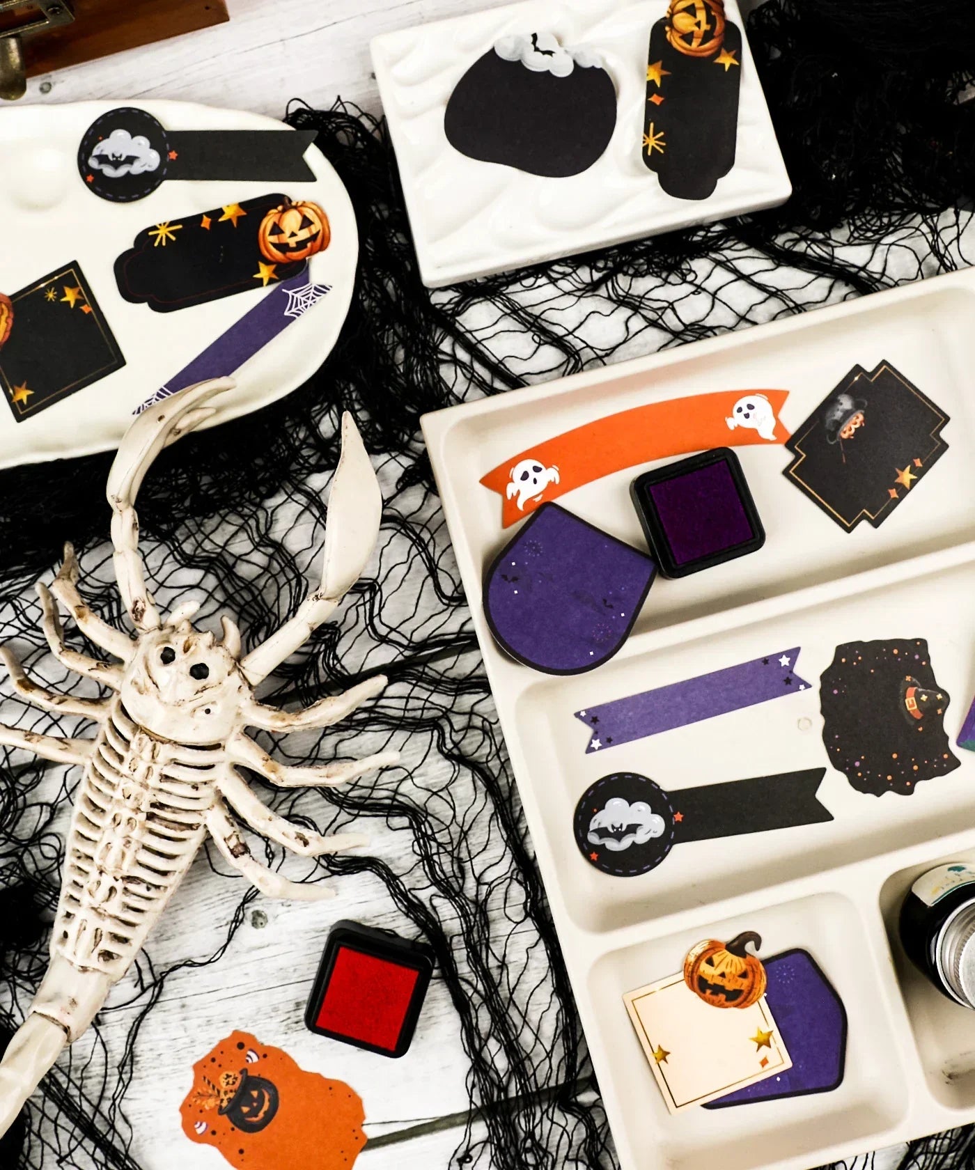 22 Pcs Grabie Exclusive Happy Haunting Sticker Set with Halloween designs and spooky art supplies on trays