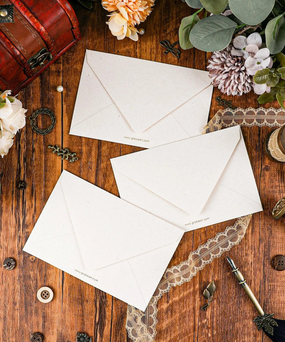 Grabie Exclusive 6 Pack Postcards With 6 Matching Envelopes arranged on wood with flowers, lace, and vintage decor accessories.