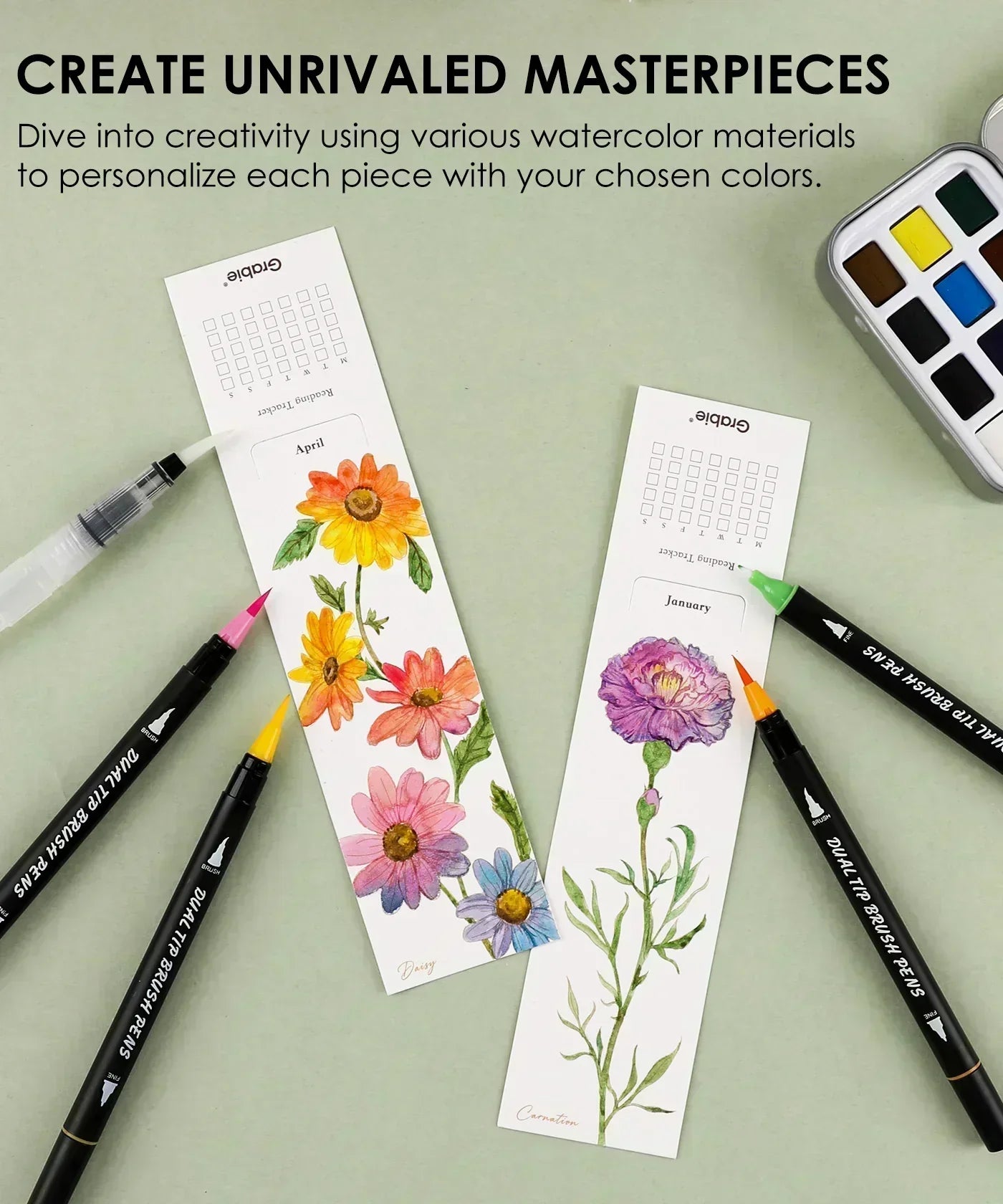 The Watercolor Beginner‘s Bundle showing floral bookmarks with dual-tip brush pens and watercolor palette on a green surface