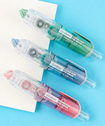Three colorful Double-Sided Adhesive Dot Runners for scrapbooking and art supplies on a blue background