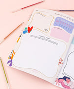 Open page of Be You And Love You 28-day Workbook with colorful pens and creative layout for hobbies and weather tracking