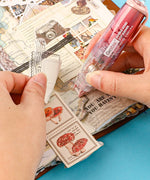 Hand applying Double-Sided Adhesive Dot Runner to scrapbook paper for crafting and art supplies projects