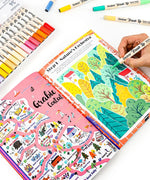 Person coloring a vibrant nature-themed page with markers next to a detailed colorful map in the Unplug And Go Outside 30-day Workbook