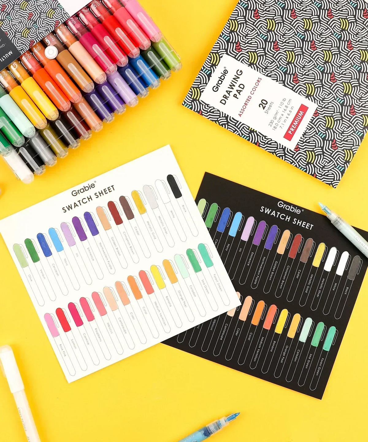 Extra Fine Tip Acrylic Paint Marker Set of 28 with colorful swatch sheets and art supplies on a bright yellow background