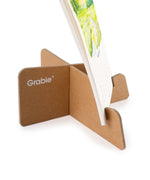 Close-up of a kraft paper stand holding the 12-Month Watercolor Calendar Set For 2026 with visible watercolor art details.