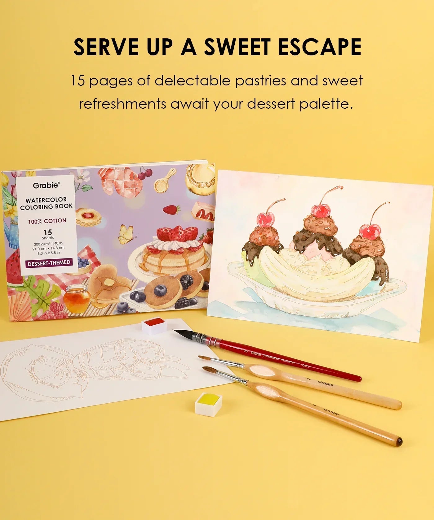 Grabie Quarterly Watercolor Coloring Club with dessert-themed book, watercolor brushes, palette, and painted banana split artwork