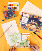 Essential-Themed Watercolor Coloring Club Box with watercolor set, brushes, and detailed nature and room illustrations being painted.