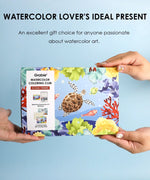 Hands holding Ocean-Themed Watercolor Coloring Club Box featuring vibrant sea life artwork including a turtle and coral reef illustrations
