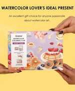 Hands holding Grabie Quarterly Watercolor Coloring Club box with dessert-themed watercolor art and gift message background