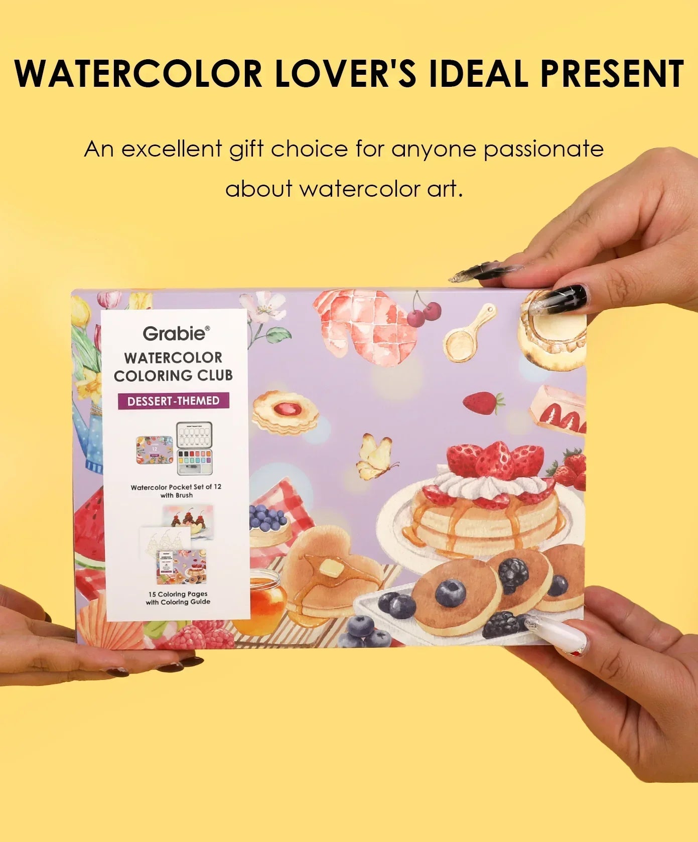 Hands holding Grabie Quarterly Watercolor Coloring Club box with dessert-themed watercolor art and gift message background