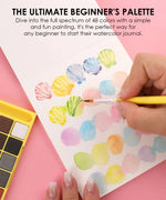 Hand painting colorful watercolor swatches with a brush using The Watercolor Beginner‘s Bundle art supplies set