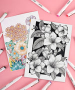 Waterproof Multiliner Drawing Pen Set Of 10 around detailed floral sketches, featuring colored and black ink art supplies.