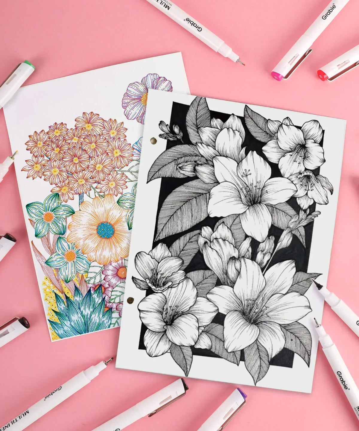 Waterproof Multiliner Drawing Pen Set Of 10 around detailed floral sketches, featuring colored and black ink art supplies.