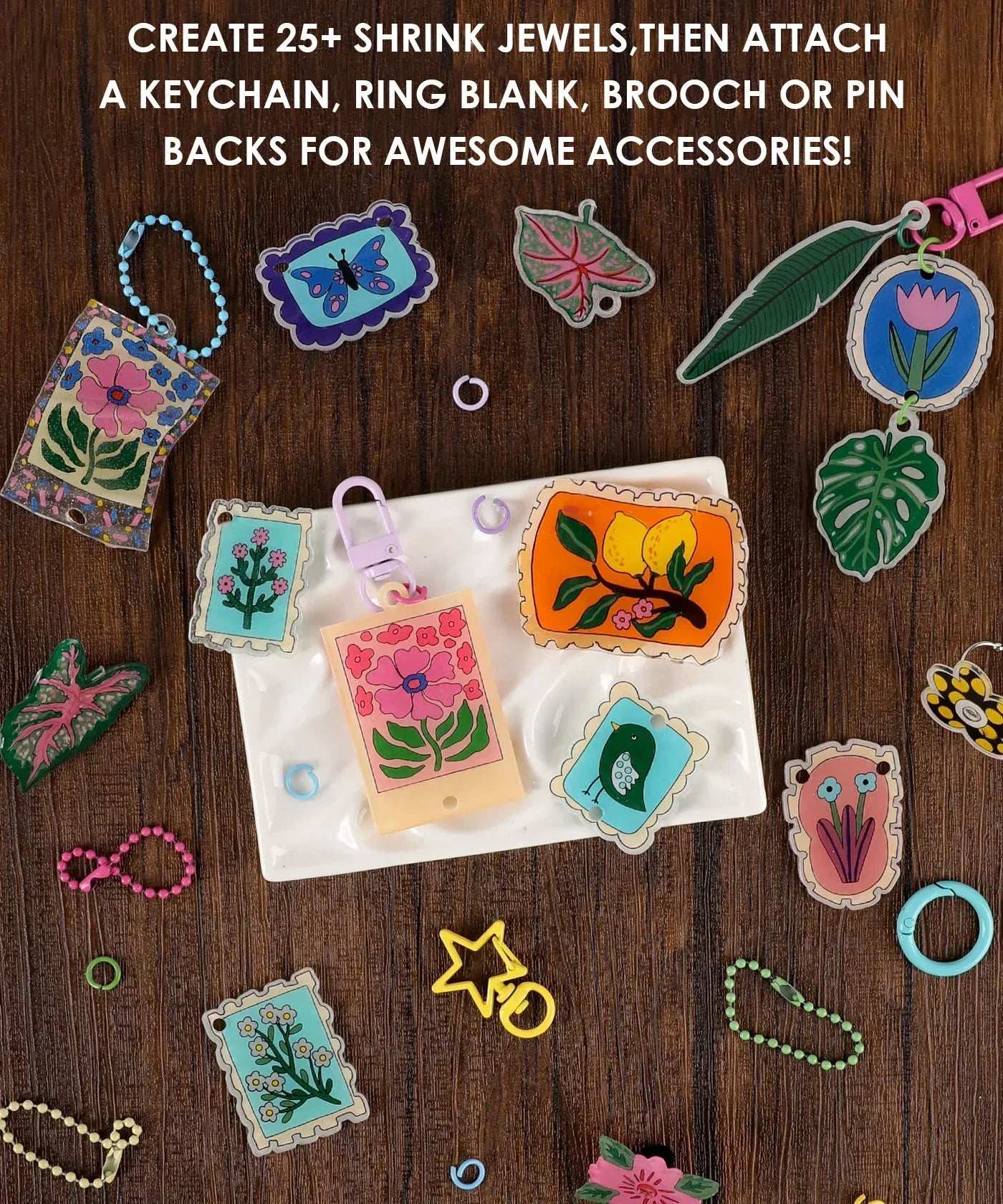 Colorful handmade shrink plastic charms displayed with keychains and rings from the Shrink to Sparkles Craft Kit (DIY Shrinky Dinks Set) 