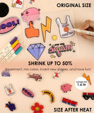 Colorful shrinkable plastic charms and markers for Shrink to Sparkles Craft Kit (DIY Shrinky Dinks Set) with art supplies displayed.