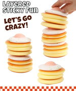 Hand stacking layers of soft pastel squishy discs with speckled topping, Grabie Ultimate Stress Relief Squishy.