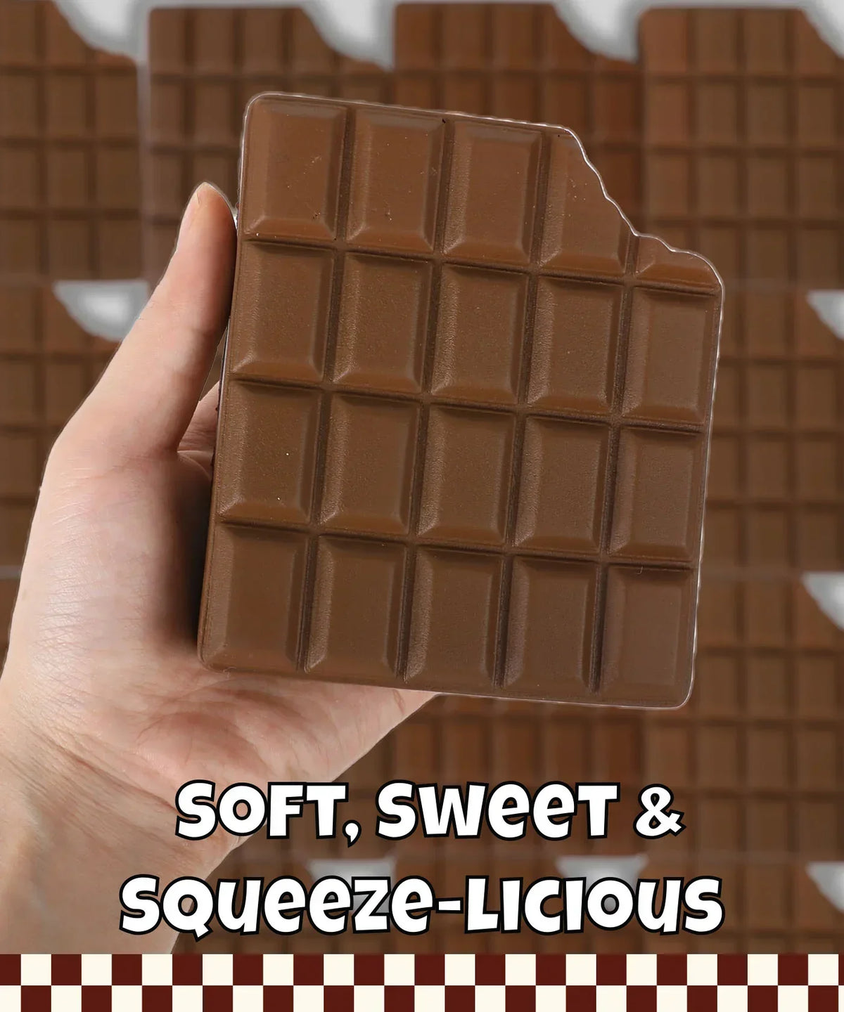 Hand holding Grabie Ultimate Stress Relief Squishy shaped like a chocolate bar with a bite taken out of the corner