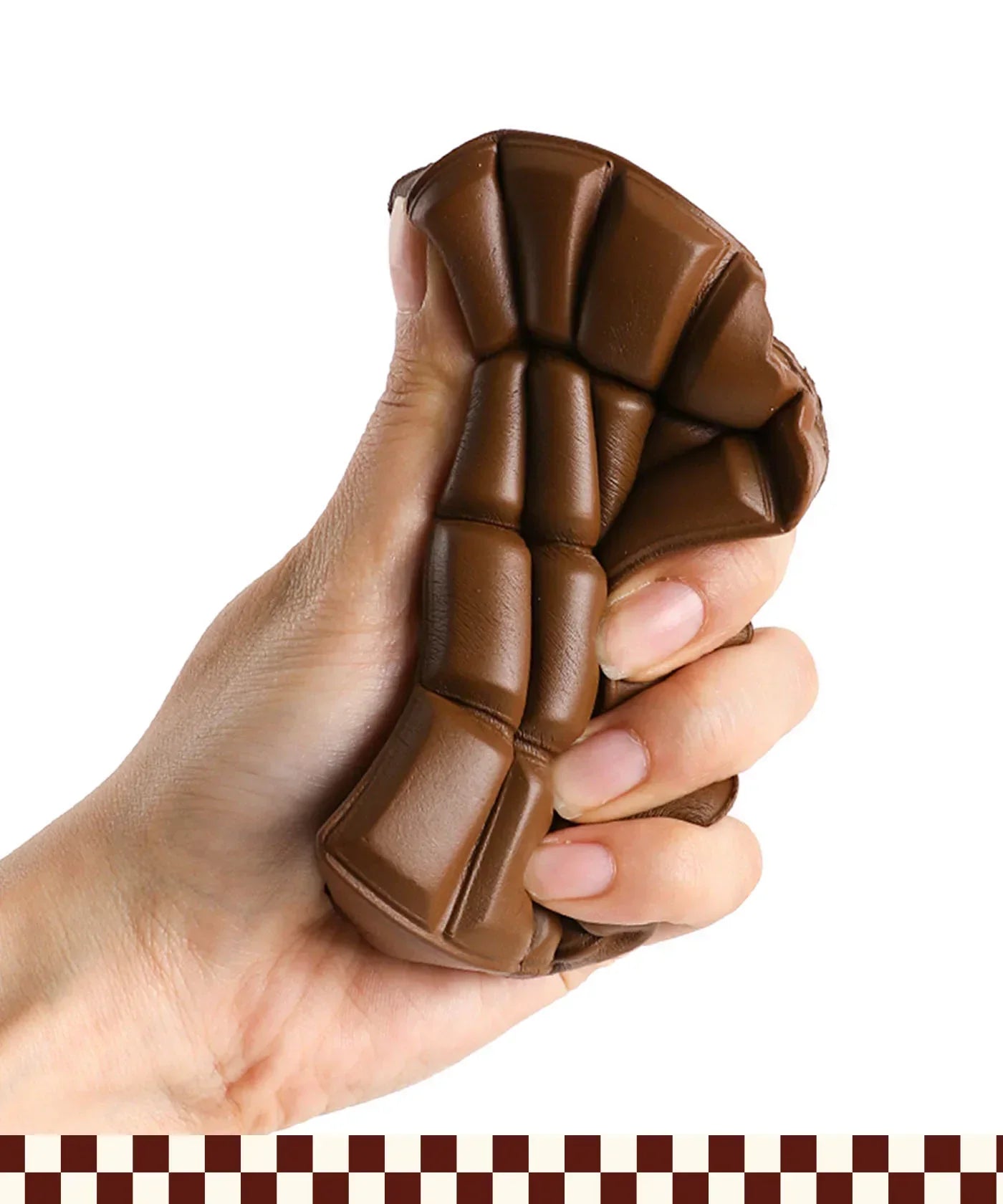 Hand squeezing brown Grabie Ultimate Stress Relief Squishy toy for stress relief and relaxation.