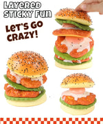 Hand stacking layers of a realistic chicken sandwich squishy toy labeled Grabie Ultimate Stress Relief Squishy for fun stress relief.