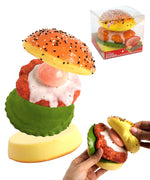 Grabie Ultimate Stress Relief Squishy shaped like a colorful teriyaki burger with hands squeezing it.