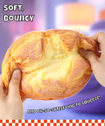 Hands squeezing a soft, bouncy Grabie Ultimate Stress Relief Squishy with a creamy texture visible inside