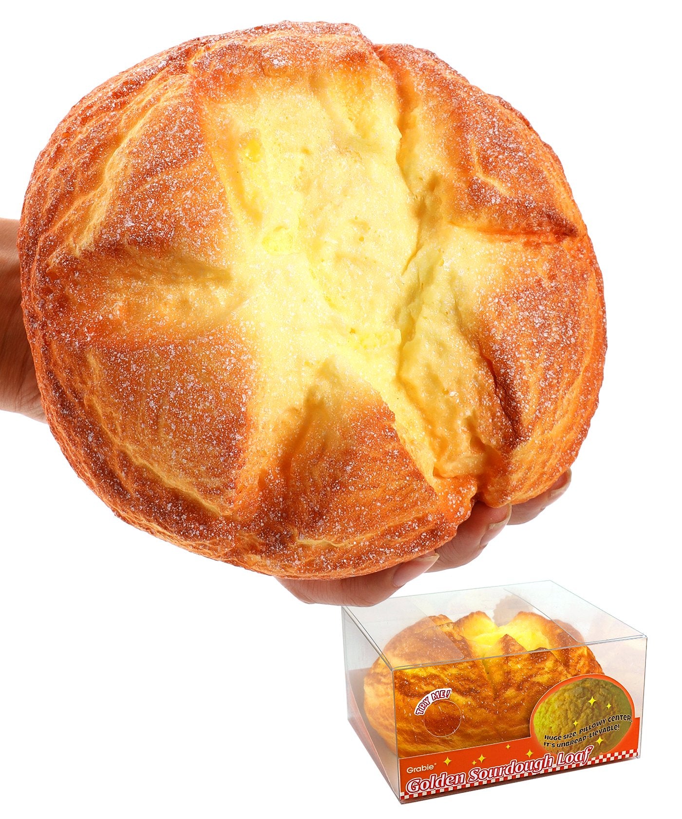 Hand squeezing a soft, yellow bread-shaped Grabie Ultimate Stress Relief Squishy toy with detailed texture and a clear display box below.