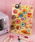 Colorful handmade magnets of donuts, bread, and breakfast items displayed on board with Magnet Painting Kit (DIY Refrigerator Magnet Kit) 