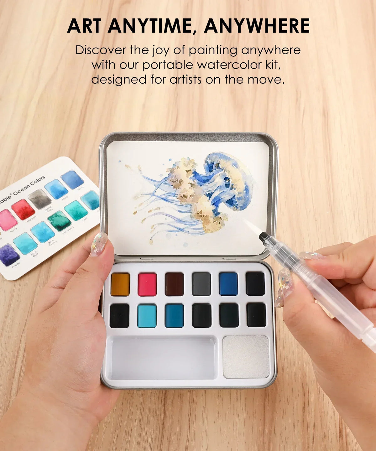 Watercolor Pocket Set Of 12 With Brush - Ocean Colors shown with a jellyfish painting in progress on a wooden surface