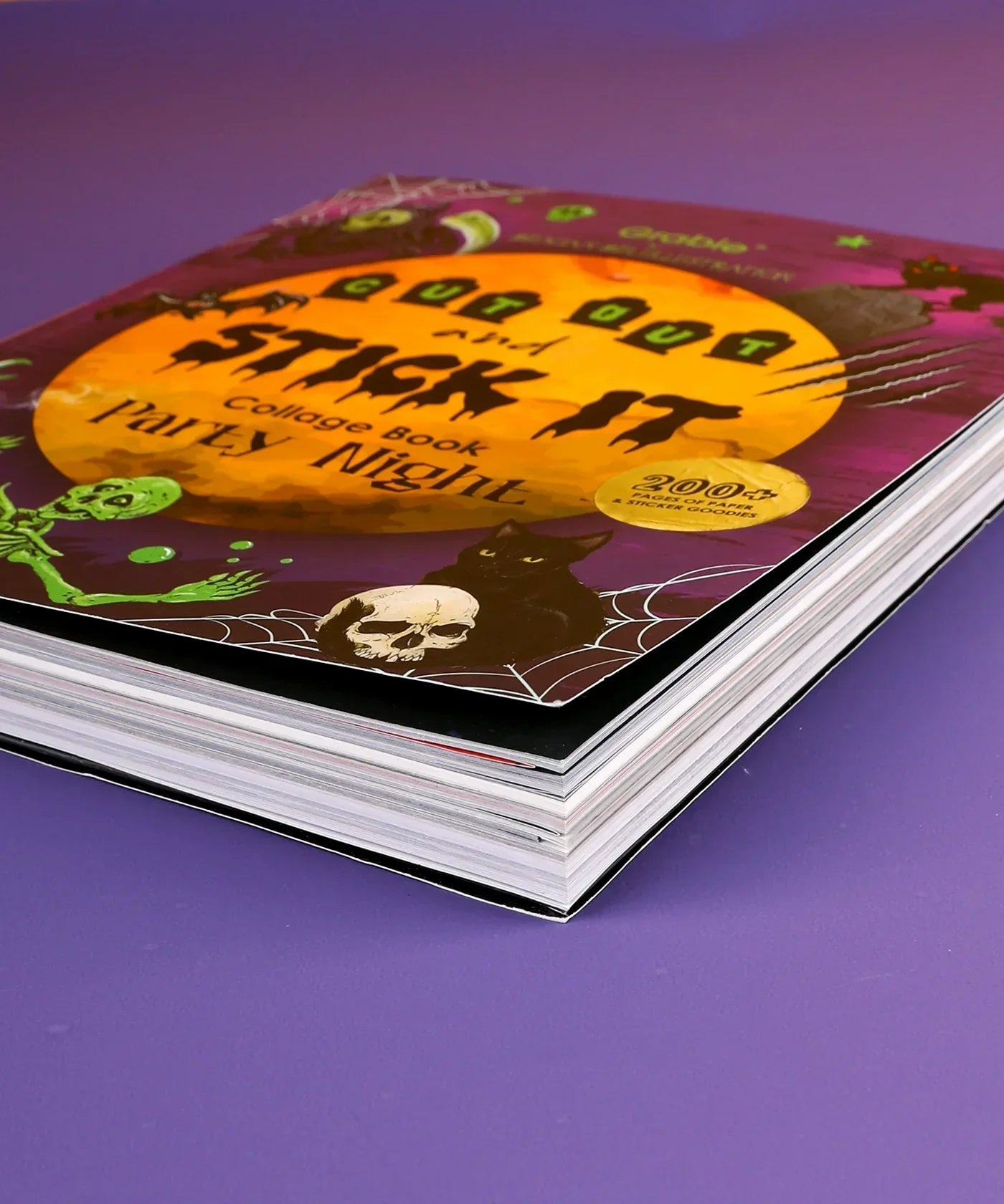 200+ Pages Halloween Party Night Collage Activity Book with Halloween-themed cover and thick pages on purple background