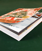 200+ Pages Holiday Magic Collage Activity Book open, showing colorful holiday-themed pages and creative art supplies inside