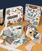 Threads Of Time-Themed Grabie Scrapbook Club Box with vintage scrapbook supplies, lace, buttons, and paper crafts arranged on table
