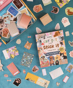 My Furry Family-Themed Grabie Scrapbook Club Box with pet stickers, patterned papers, and crafting supplies spread out on blue surface