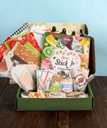 Open box of art supplies including a collage book, papers, and scrapbook materials for The Flavor Folio-Themed Grabie Scrapbook Club Box