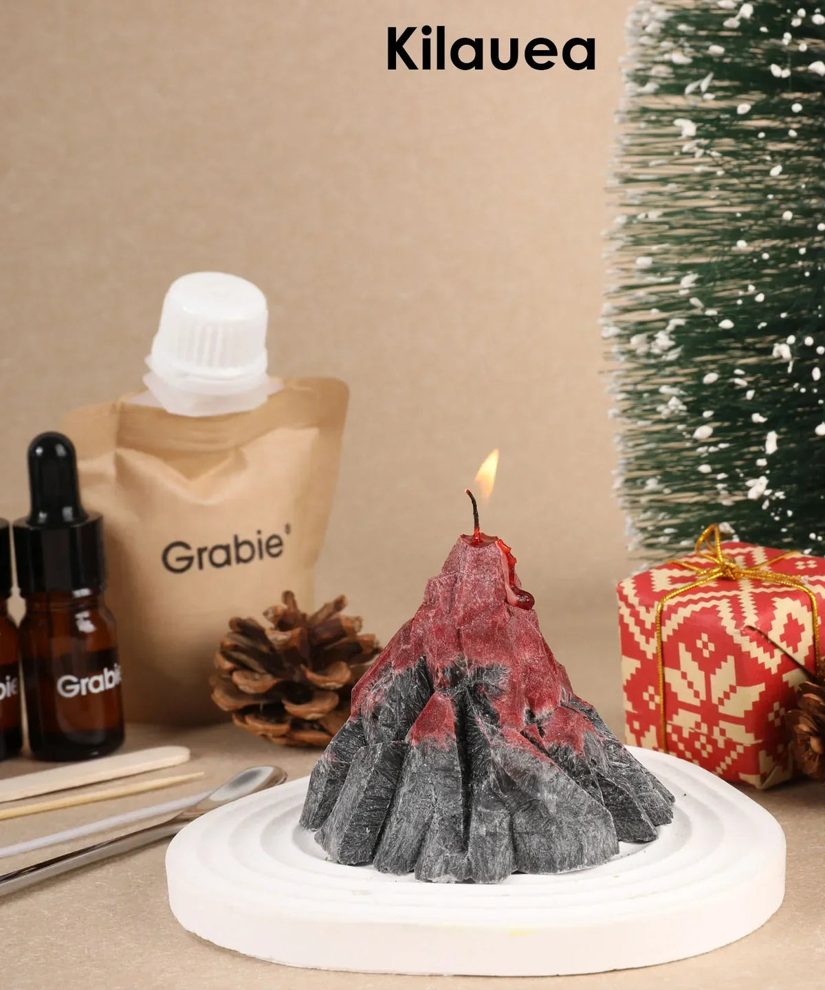 Scent Candle DIY Set showing lit volcano-shaped candle with crafting supplies and holiday decorations nearby