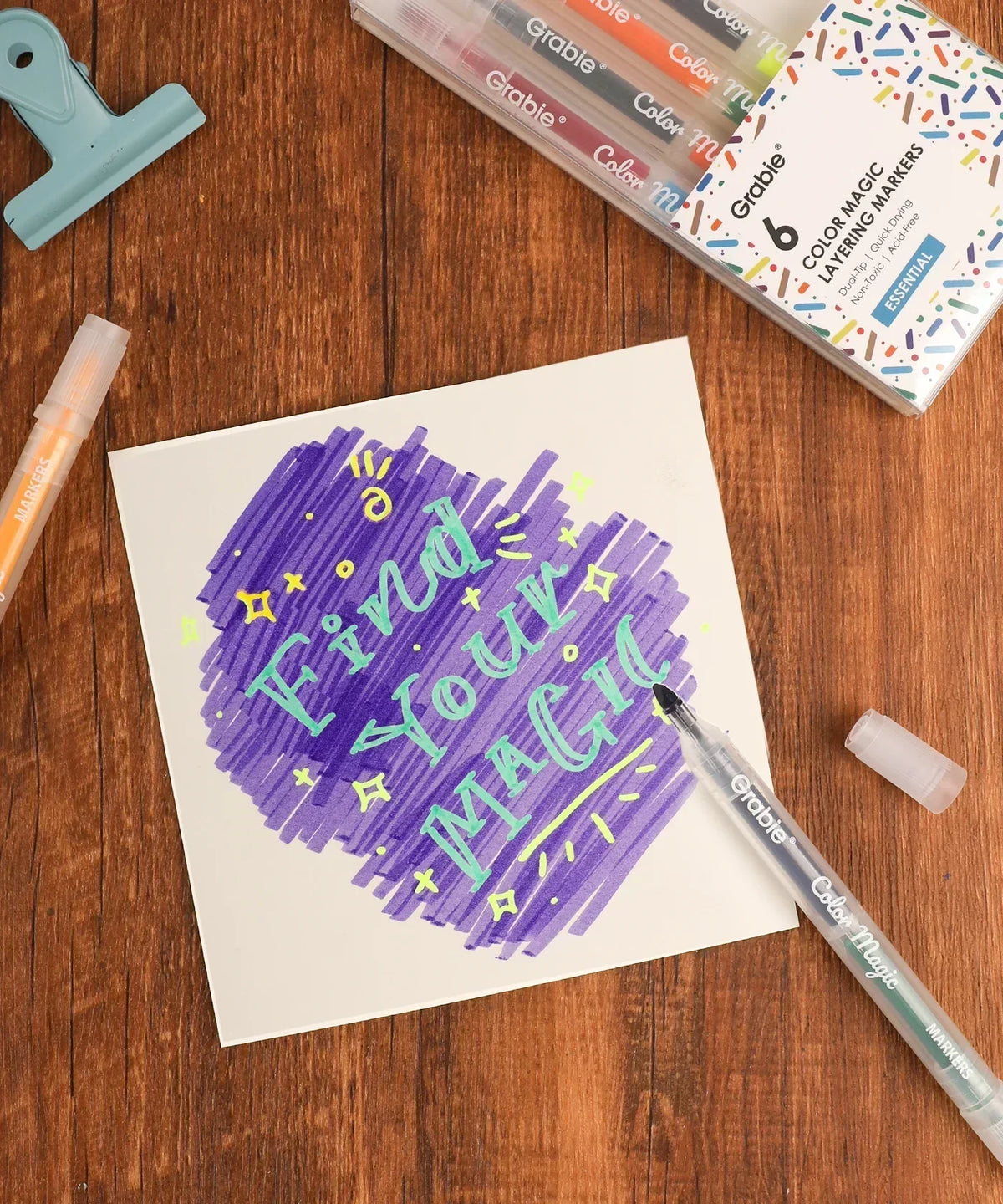 Color Magic Layering Marker Set for Wholesale displayed with handwritten note "Find your magic" in vibrant colors on wooden surface.