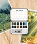 Watercolor Pocket Set Of 12 With Brush - Forest Colors open with brush and green watercolor paintings on wood surface