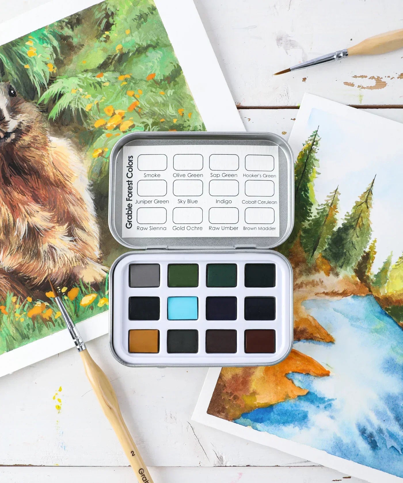 Watercolor Pocket Set of 12 - Forest Colors with paintbrush and nature-themed watercolor artwork on white surface.