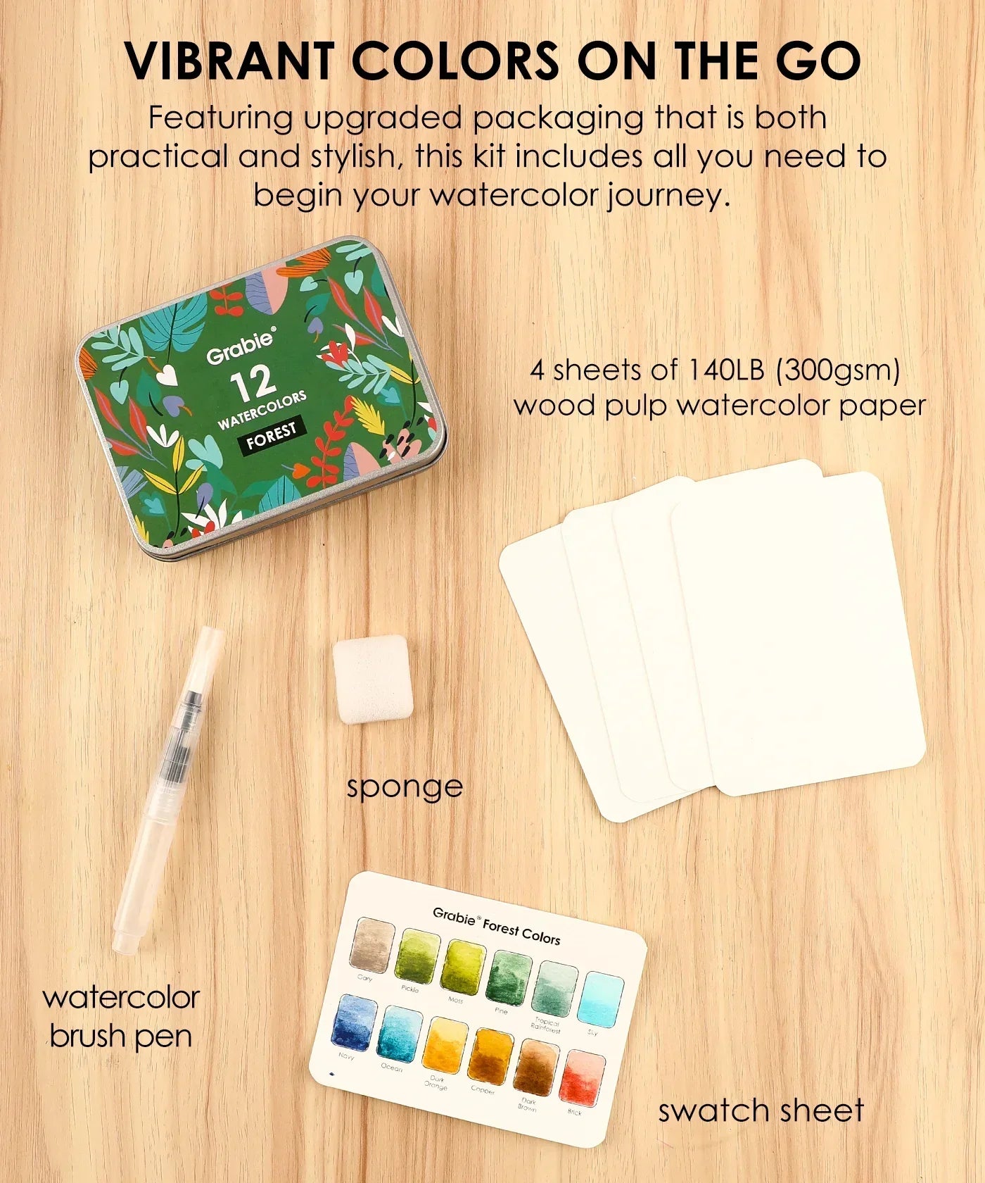 Watercolor Pocket Set Of 12 With Brush - Forest Colors featuring brush pen, sponge, swatch sheet, and paper sheets on wood background