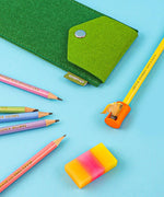 Colorful Inspirational Sketch Pencil Set with sharpened pencils, sharpener, eraser, and green felt pencil case on blue background