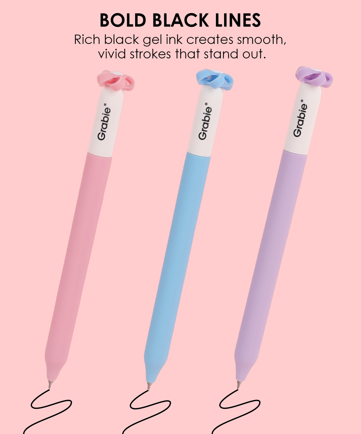Three colorful Mindful Bloom novelty pens drawing smooth bold black lines on a light pink background.