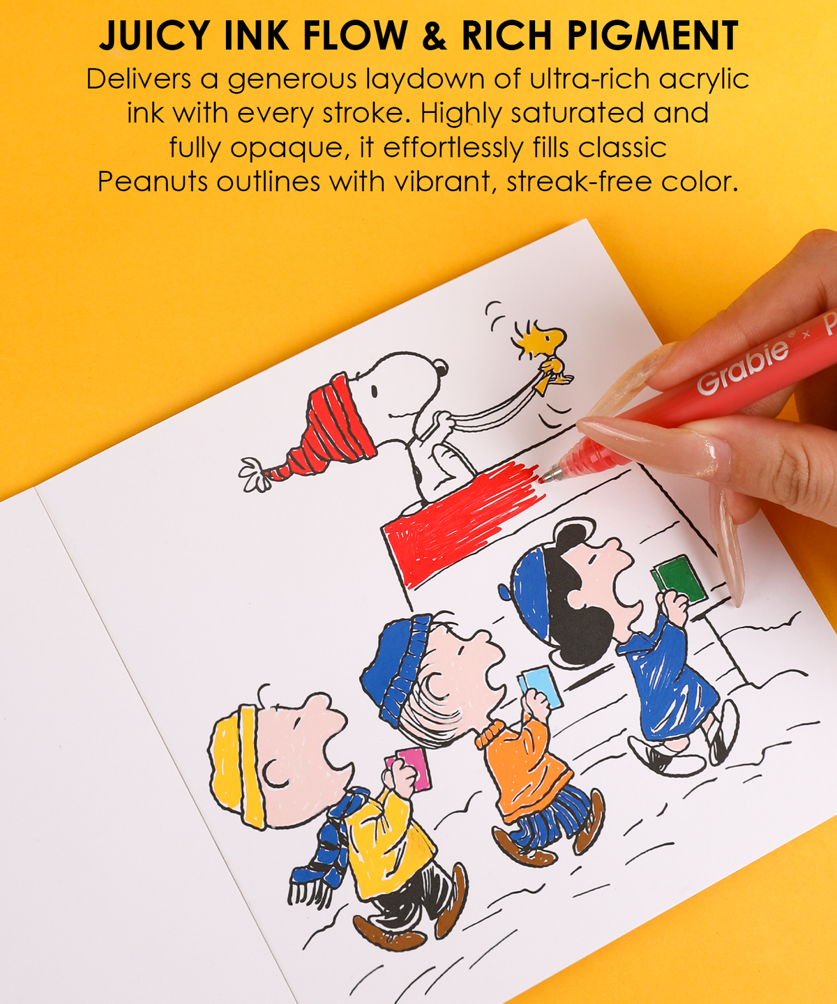 Hand coloring Snoopy and Woodstock comic panel illustration using a red Peanuts acrylic gel pen.