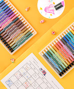 Erasable gel pens next to a drawn monthly planner with a inset circle showing heart drawing being erased.